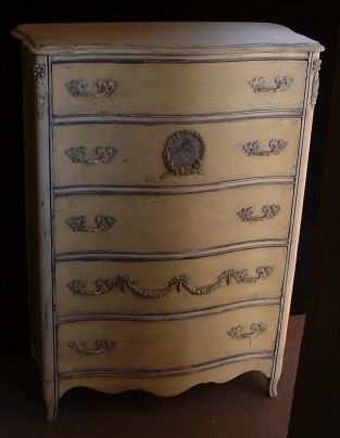 Yellow and ivory serpentine dresser; age uncertain.